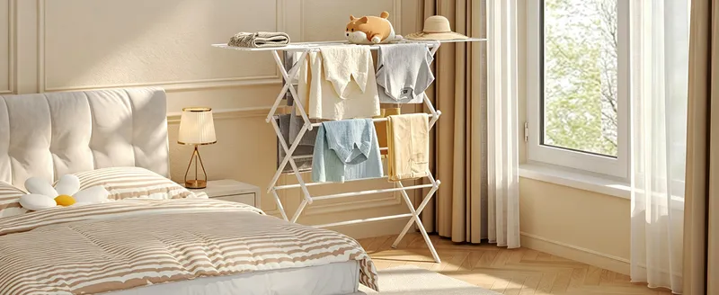 Drying rack with shirts and towels in a sunny bedroom
